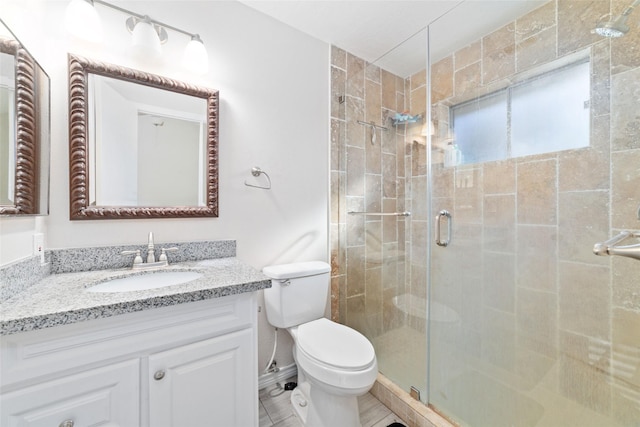 bathroom featuring vanity, toilet, and walk in shower