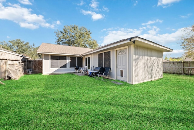 rear view of house with a yard