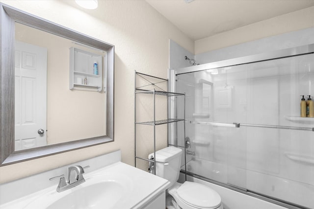 full bathroom featuring vanity, toilet, and enclosed tub / shower combo