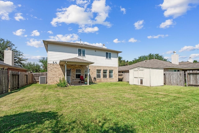 rear view of house featuring a yard, a shed, cooling unit, and a patio area