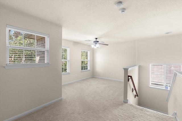 carpeted empty room with ceiling fan