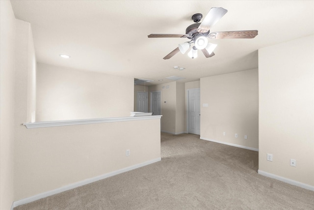 carpeted spare room featuring ceiling fan