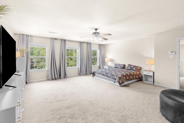 bedroom with ceiling fan and light carpet