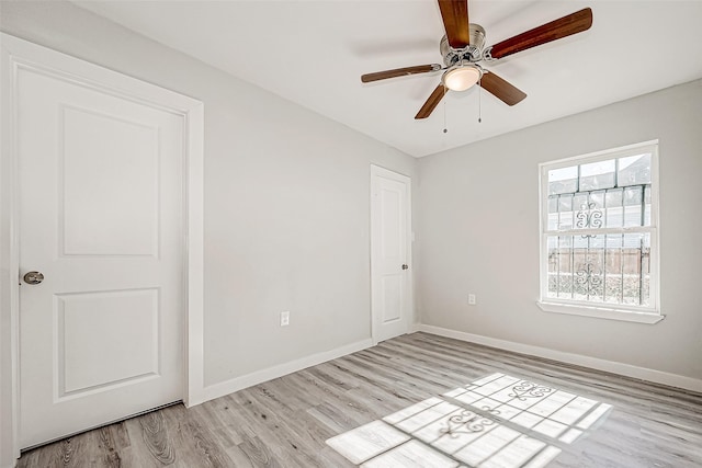 spare room featuring ceiling fan and light hardwood / wood-style flooring