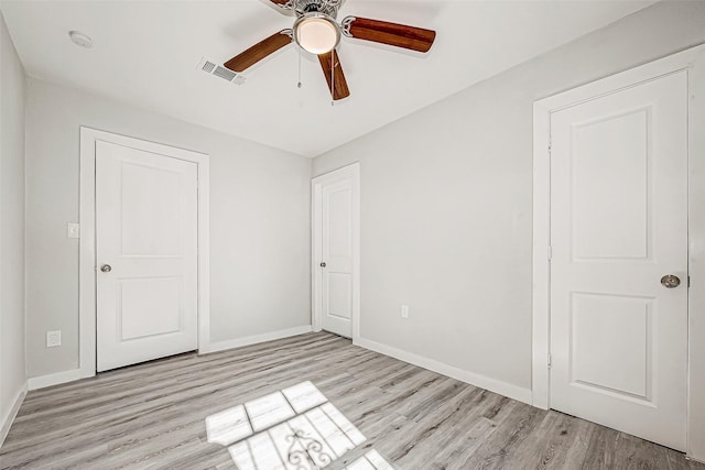 unfurnished bedroom with ceiling fan and light hardwood / wood-style flooring