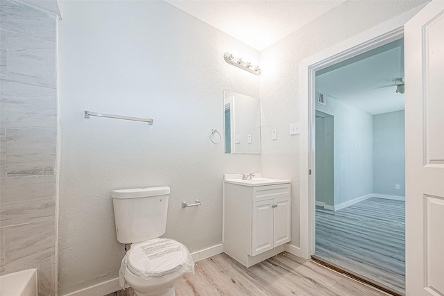 bathroom featuring wood-type flooring, vanity, and toilet