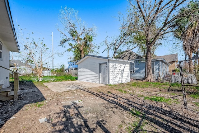 view of yard featuring a patio and a storage unit