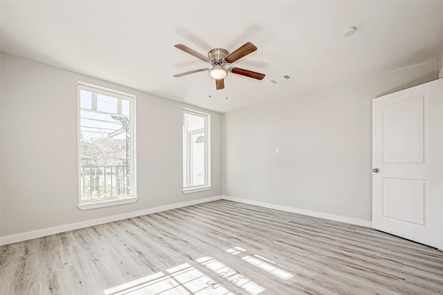 spare room with light wood-type flooring and ceiling fan