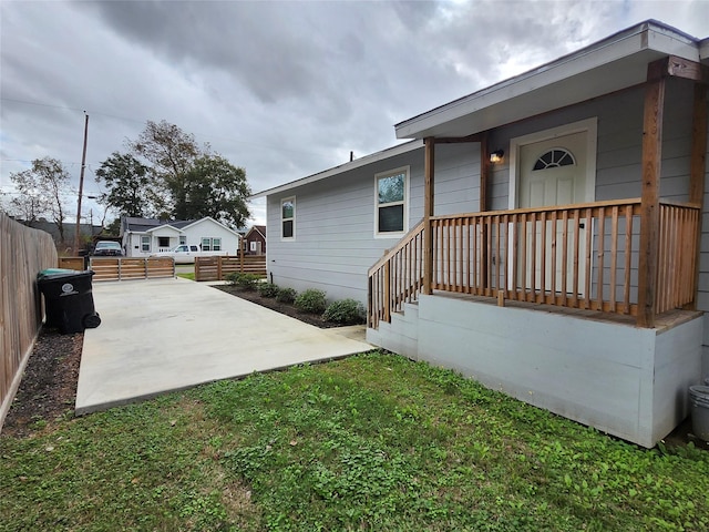 view of side of property with a lawn and a patio