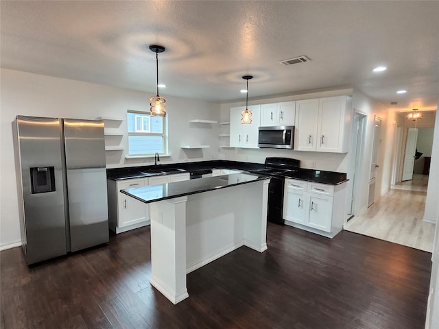 kitchen with white cabinetry, a kitchen island, and stainless steel appliances