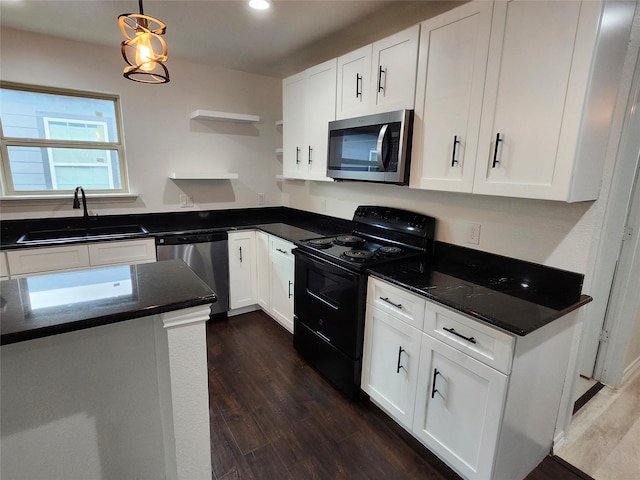 kitchen featuring appliances with stainless steel finishes, sink, decorative light fixtures, dark hardwood / wood-style floors, and white cabinetry