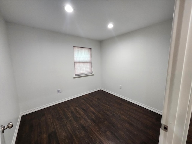 empty room with dark hardwood / wood-style flooring