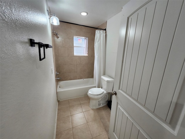 bathroom featuring tile patterned flooring, toilet, and shower / bathtub combination with curtain