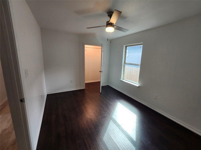 unfurnished bedroom with ceiling fan and dark hardwood / wood-style floors