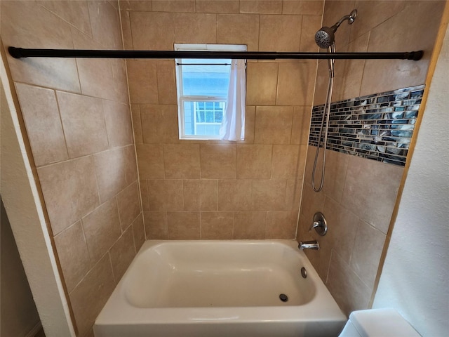 bathroom with tiled shower / bath combo