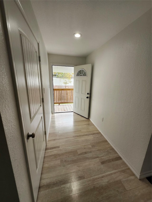 hall with light wood-type flooring