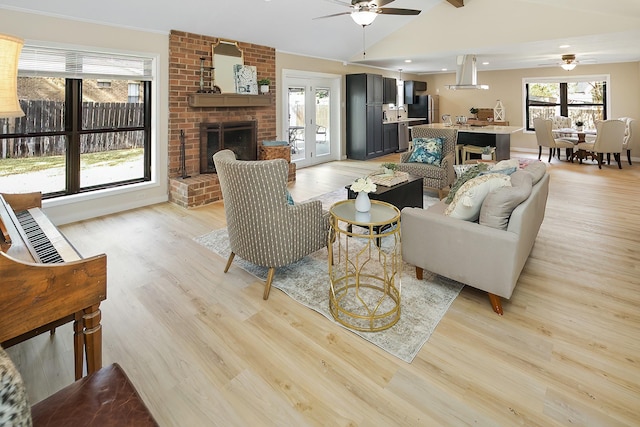 living room featuring ceiling fan, lofted ceiling with beams, and light hardwood / wood-style floors