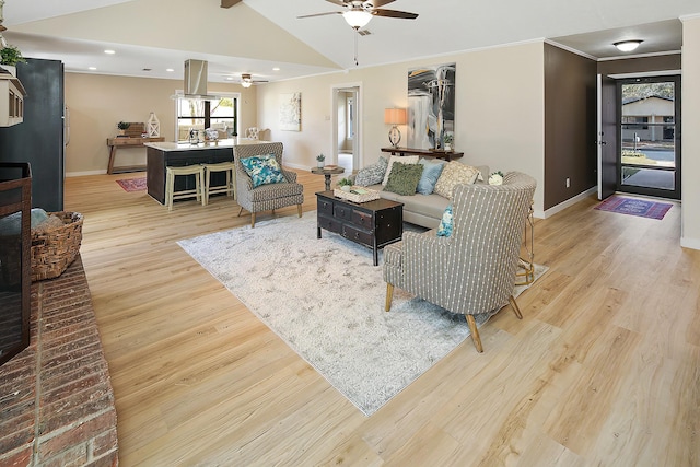 living room with vaulted ceiling with beams, ceiling fan, and light hardwood / wood-style flooring