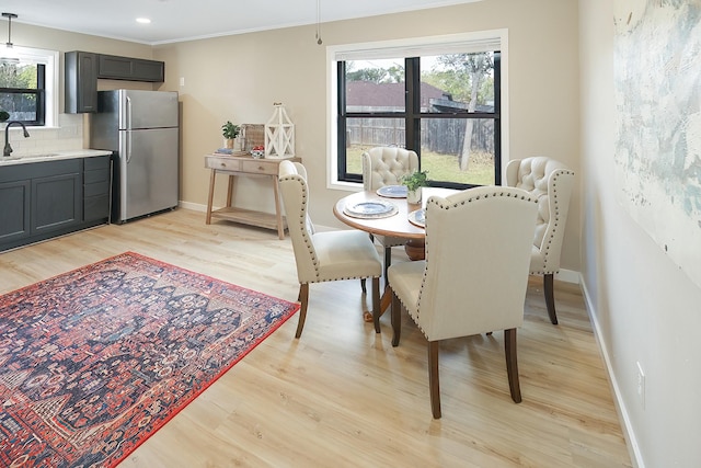 dining area with light hardwood / wood-style flooring and sink