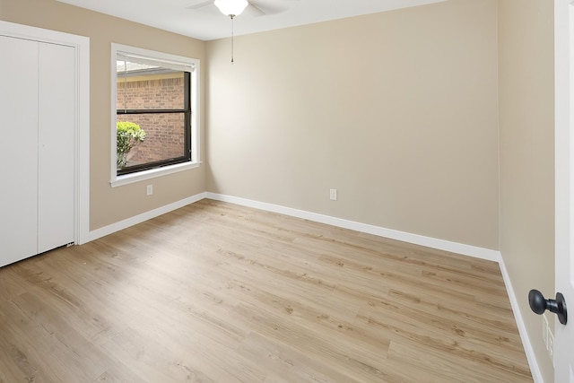 unfurnished bedroom with ceiling fan and light wood-type flooring