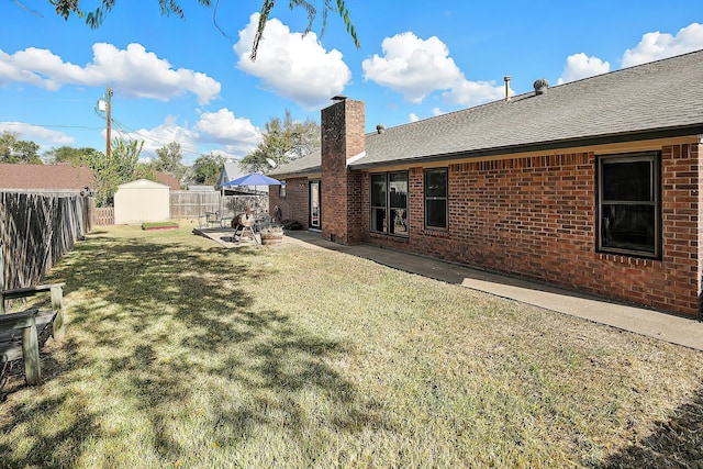 view of yard with a patio and a storage shed