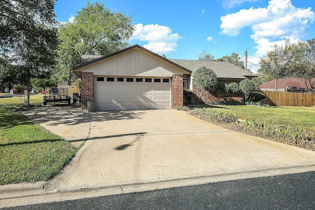 single story home with a garage and a front lawn