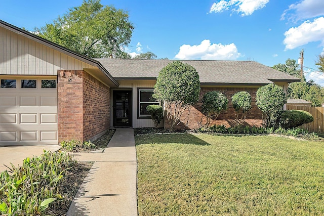 ranch-style house featuring a front yard and a garage