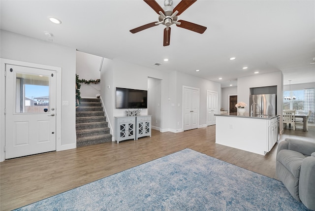 living room featuring ceiling fan, dark wood-type flooring, and a wealth of natural light