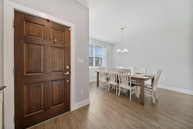 dining room featuring a chandelier and light hardwood / wood-style floors