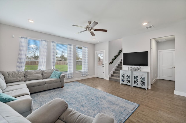 living room featuring ceiling fan and hardwood / wood-style flooring