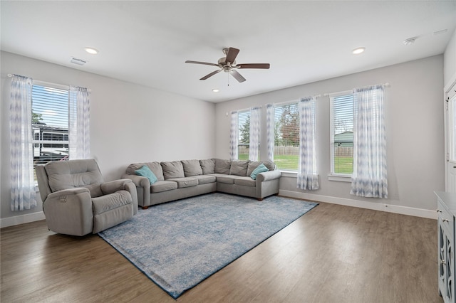 living room with hardwood / wood-style floors, ceiling fan, and a healthy amount of sunlight