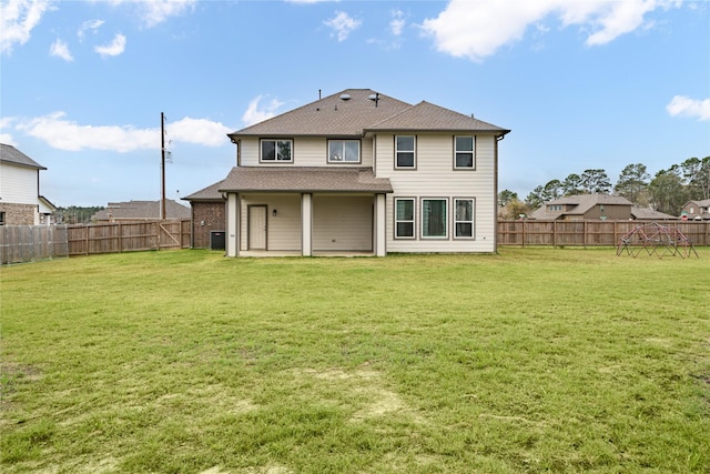 rear view of property featuring a yard