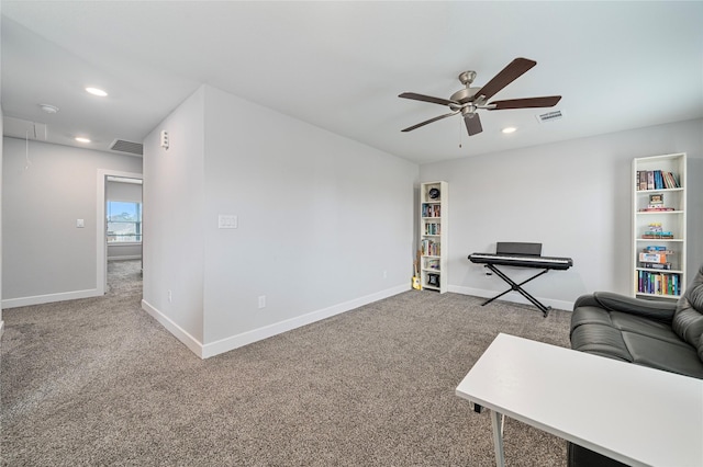 carpeted living room with ceiling fan