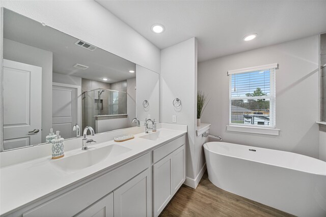 bathroom featuring wood-type flooring, vanity, and independent shower and bath