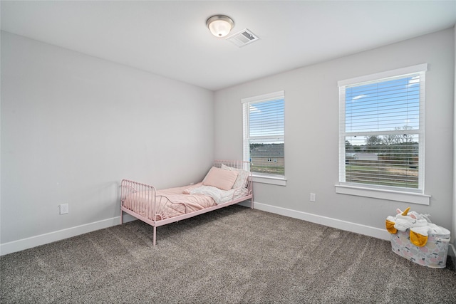 unfurnished bedroom with dark carpet