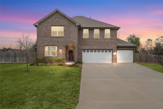 front facade featuring a yard and a garage