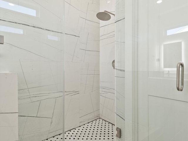 bathroom with a shower with shower door