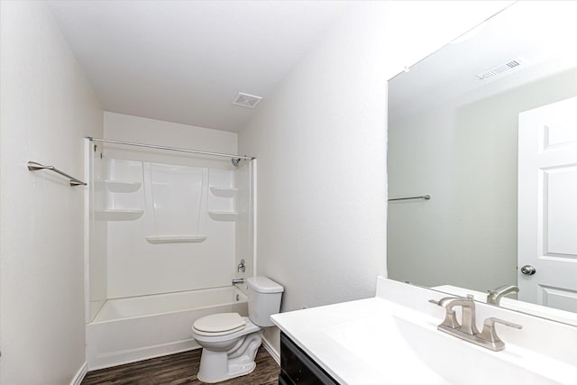 full bathroom with hardwood / wood-style floors, vanity, toilet, and shower / bath combination