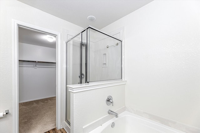 bathroom featuring shower with separate bathtub