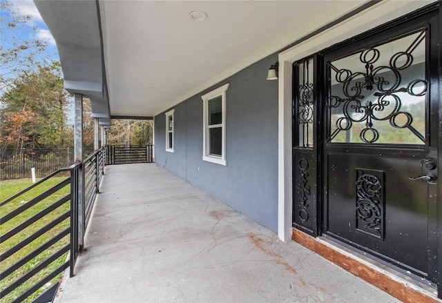 view of exterior entry featuring a porch