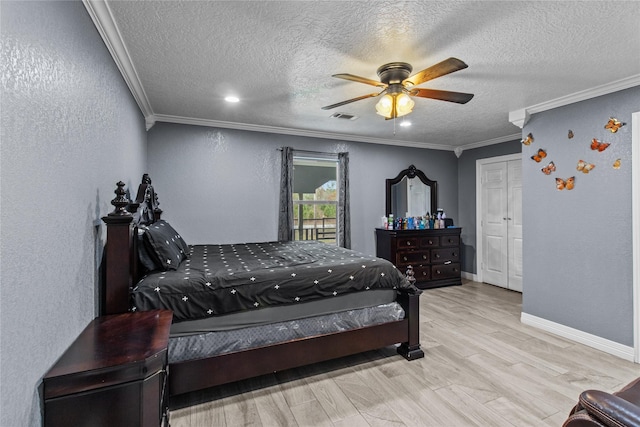 bedroom featuring ceiling fan, light hardwood / wood-style floors, ornamental molding, and a closet