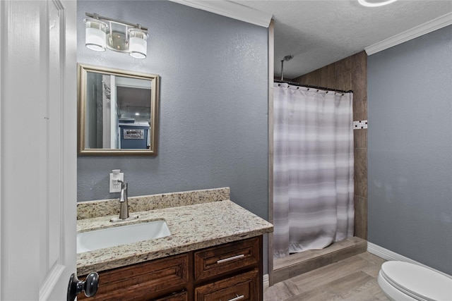 bathroom with ornamental molding, vanity, a textured ceiling, toilet, and curtained shower