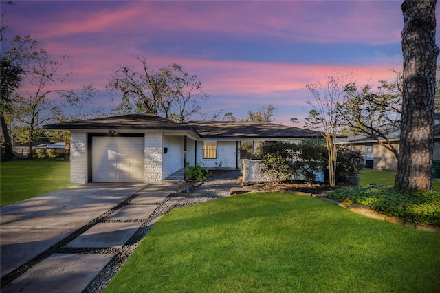 single story home with a yard and a garage