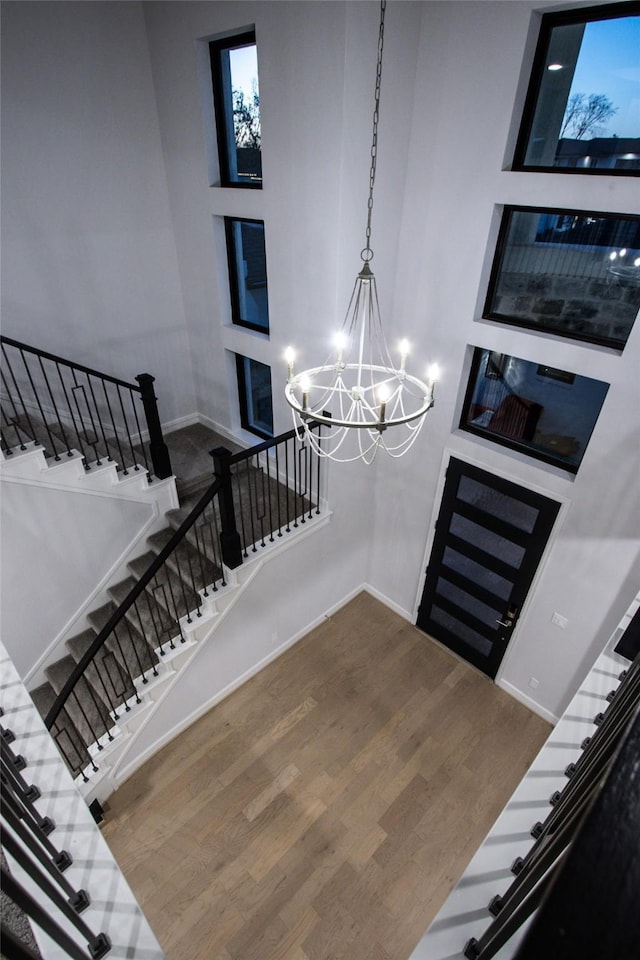 entryway featuring hardwood / wood-style flooring and an inviting chandelier