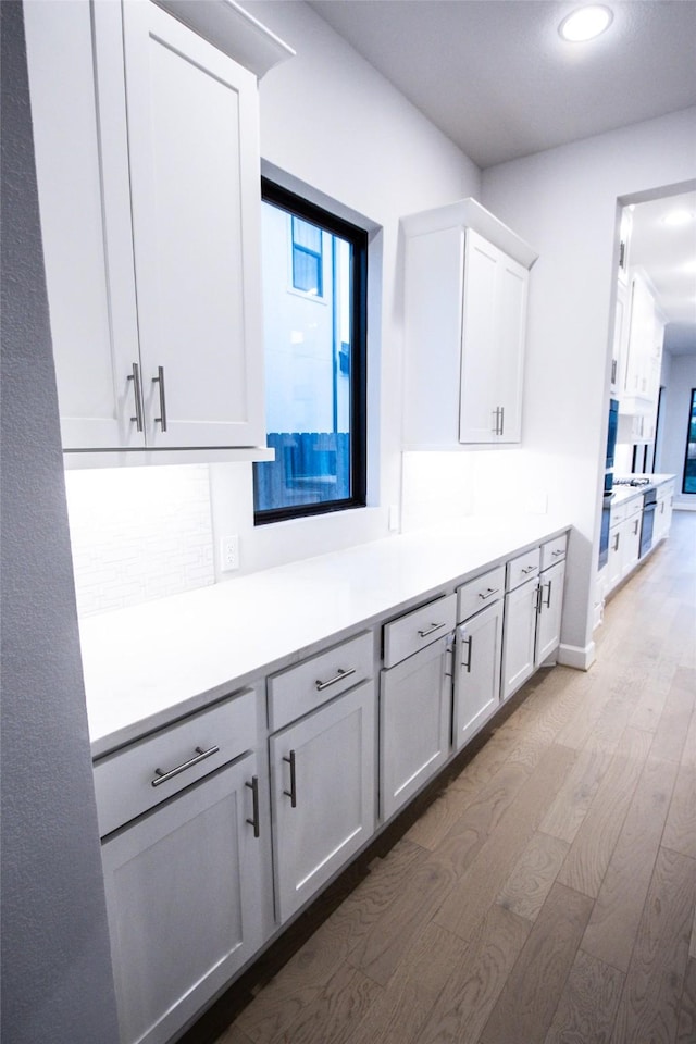 kitchen featuring light wood-type flooring and white cabinetry