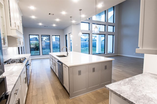 kitchen with sink, white cabinetry, an island with sink, and stainless steel appliances