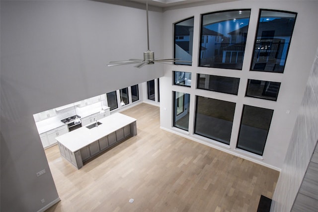 living room featuring ceiling fan and light hardwood / wood-style flooring