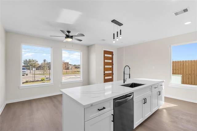 kitchen featuring sink, pendant lighting, a center island with sink, dishwasher, and white cabinetry