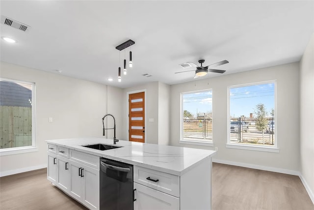 kitchen featuring light stone countertops, sink, pendant lighting, dishwasher, and white cabinets