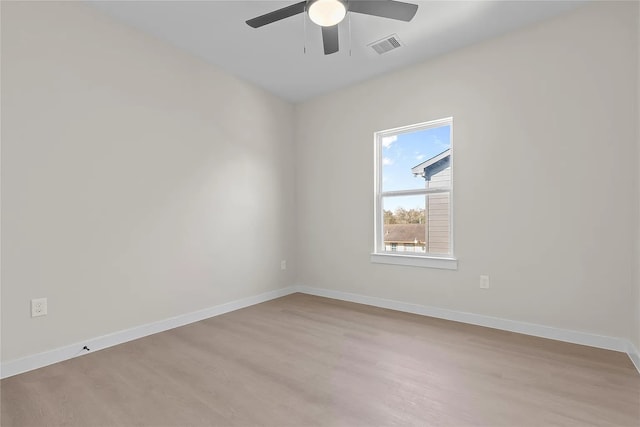 spare room with light wood-type flooring and ceiling fan